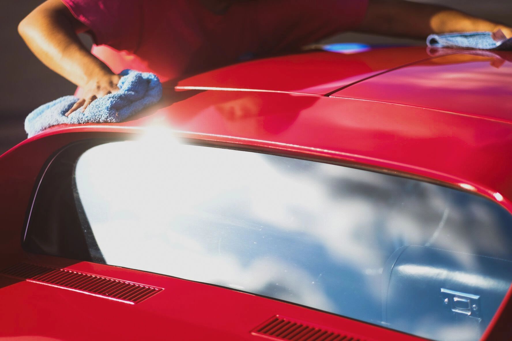 Car wash workers cleaning vehicle exterior